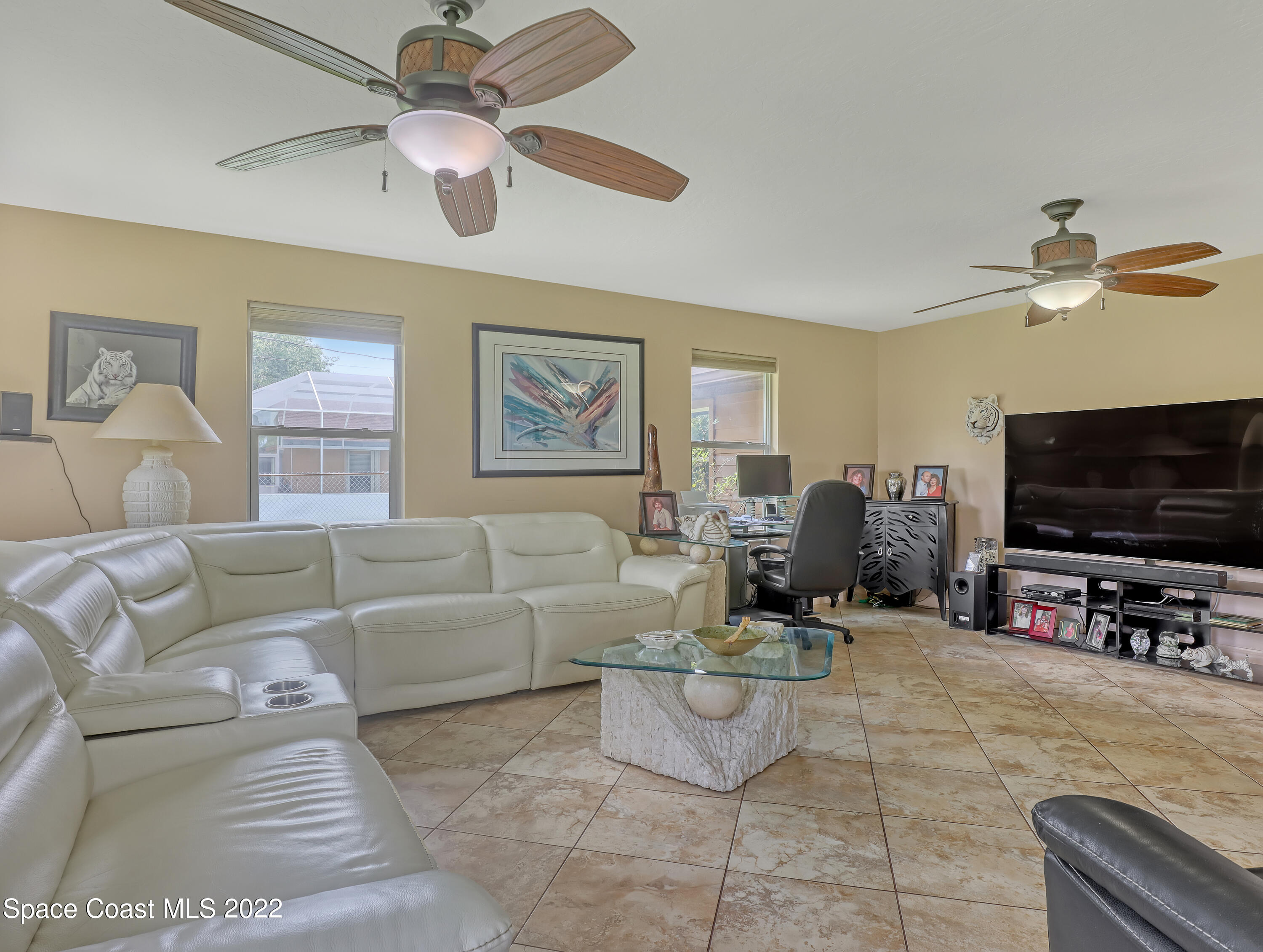 409 Rheine Road Northwest Palm Bay, FL 32907 - Photo 28 of 33 a living room with furniture and a flat screen tv