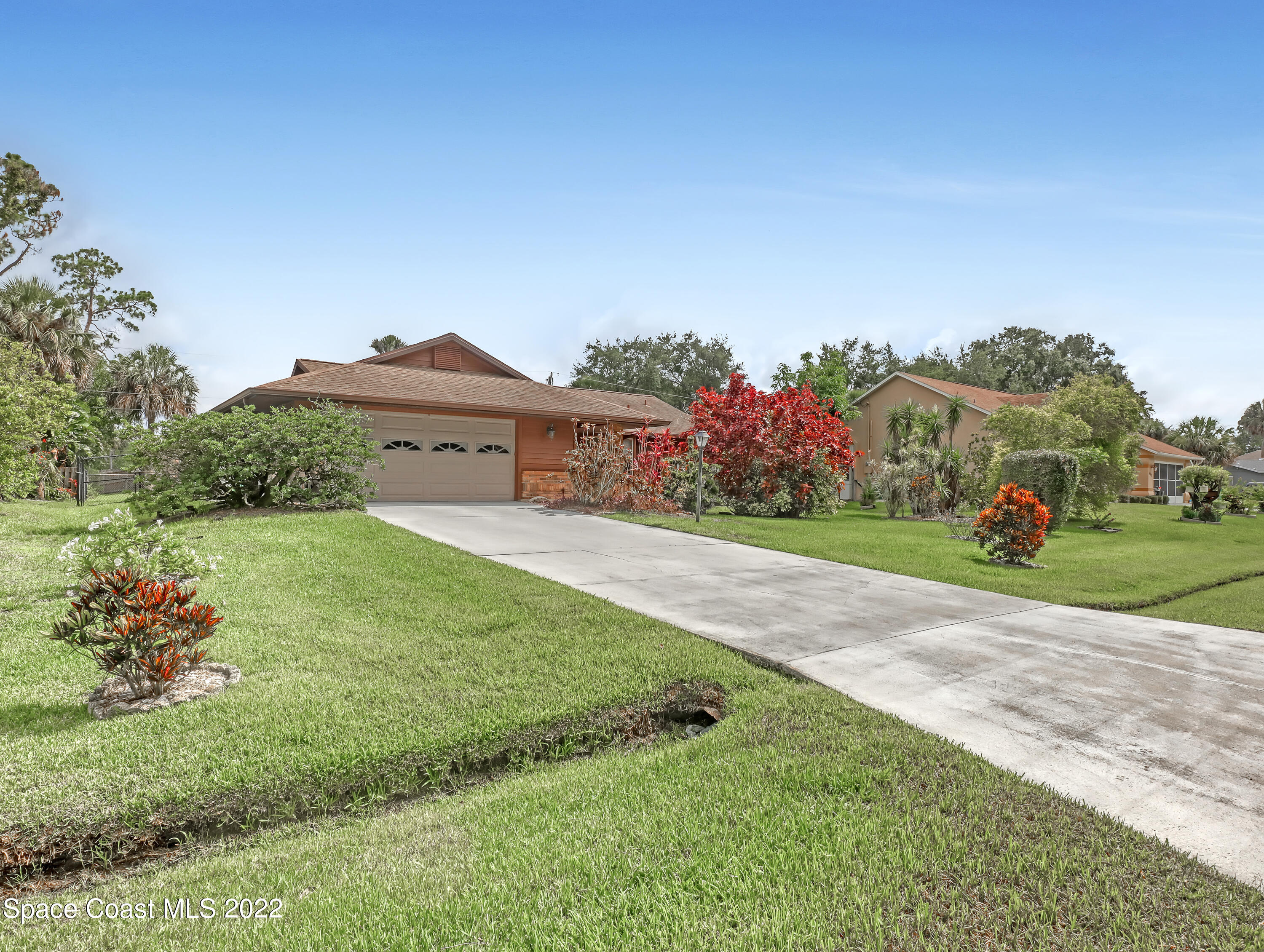 409 Rheine Road Northwest Palm Bay, FL 32907 - Photo 3 of 33 a front view of a house with a yard and garage