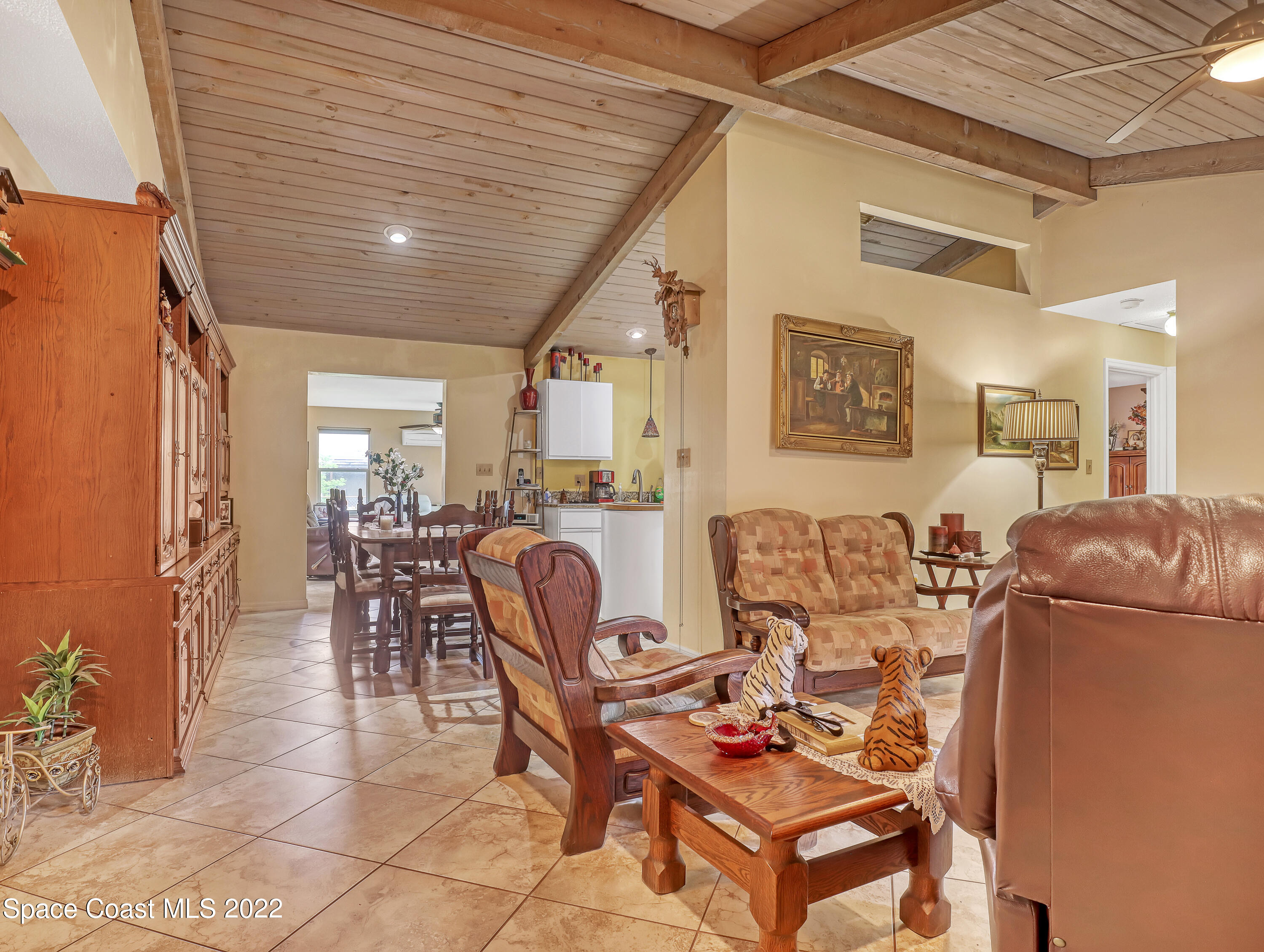 409 Rheine Road Northwest Palm Bay, FL 32907 - Photo 7 of 33 a living room with furniture and a dining table with kitchen appliances