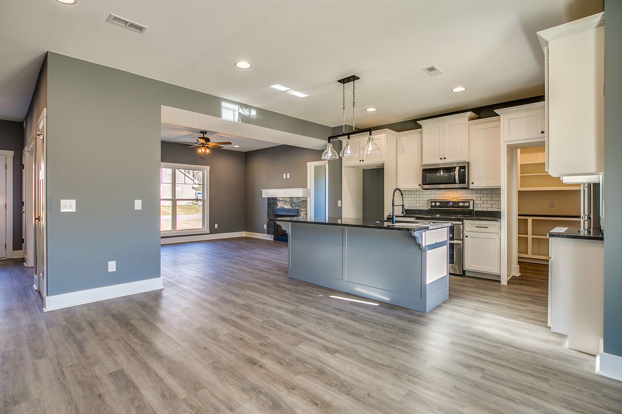 42 Post Road Manchester, TN 37355 - Photo 7 of 43 a kitchen with kitchen island white cabinets and stainless steel appliances