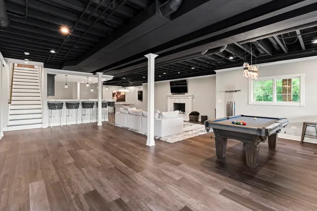 a living room with furniture and wooden floors