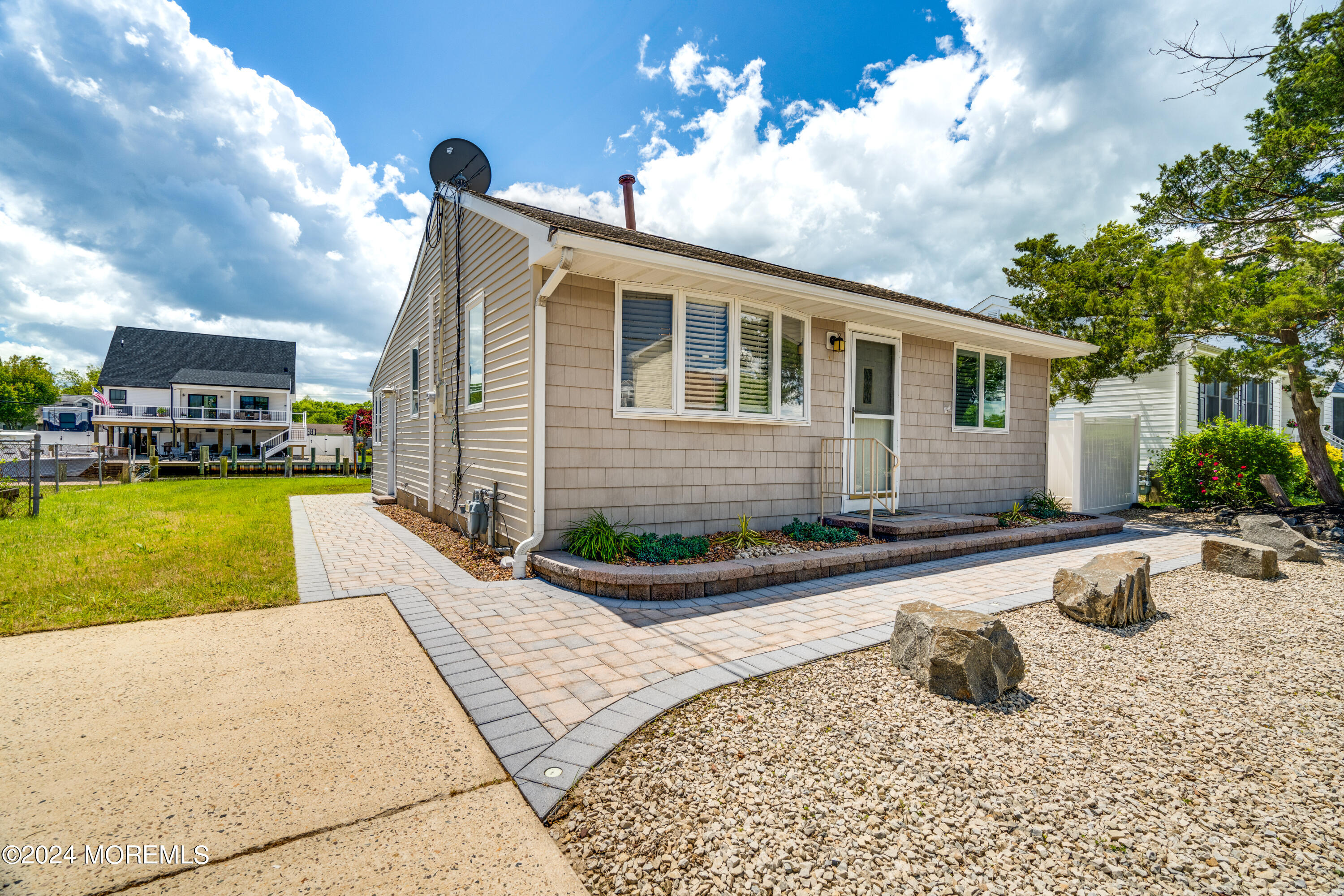 a front view of a house with swimming pool having outdoor seating