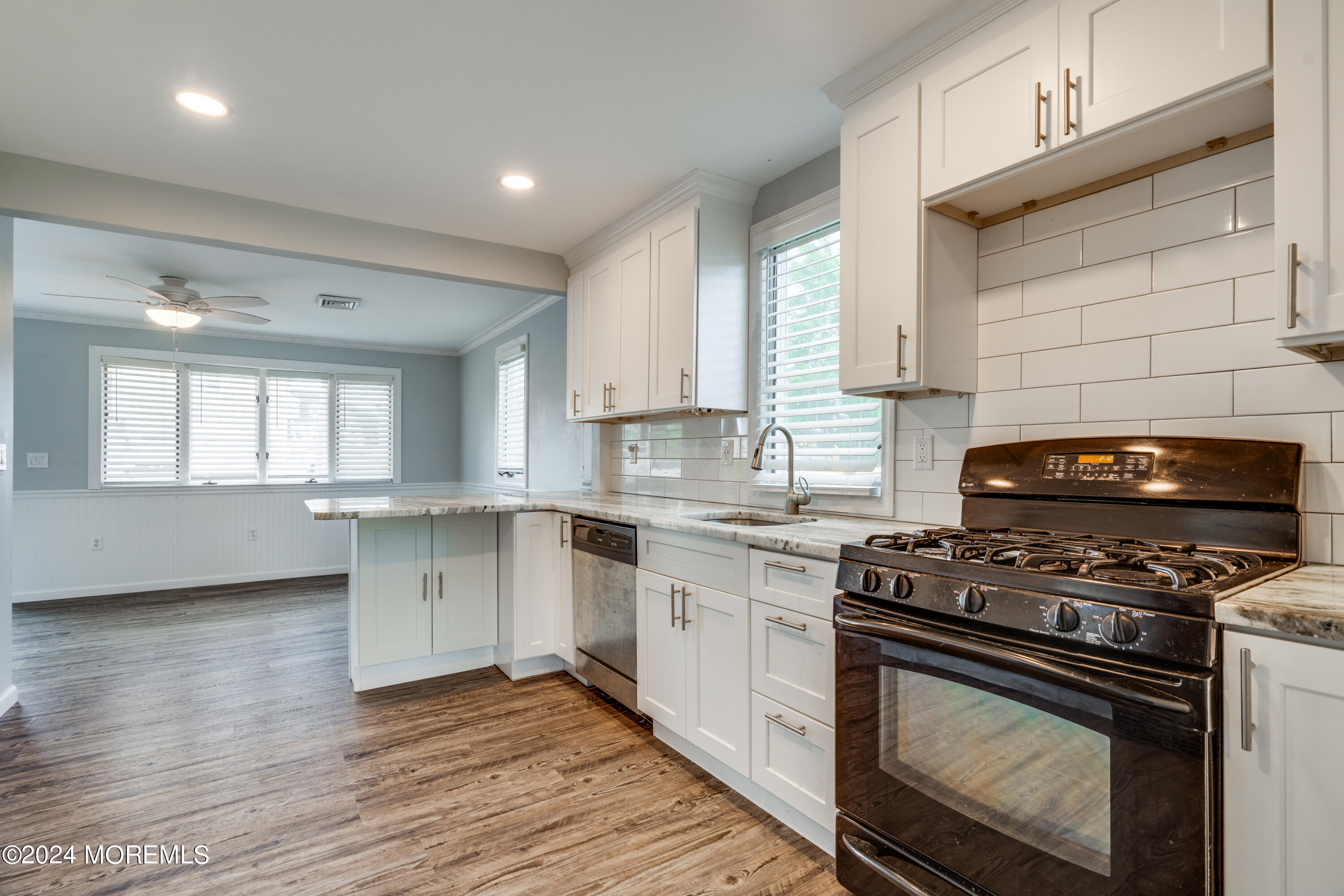 14 Bayview Drive Waretown, NJ 08758 - Photo 11 of 35 a kitchen with a stove a sink and wooden floor