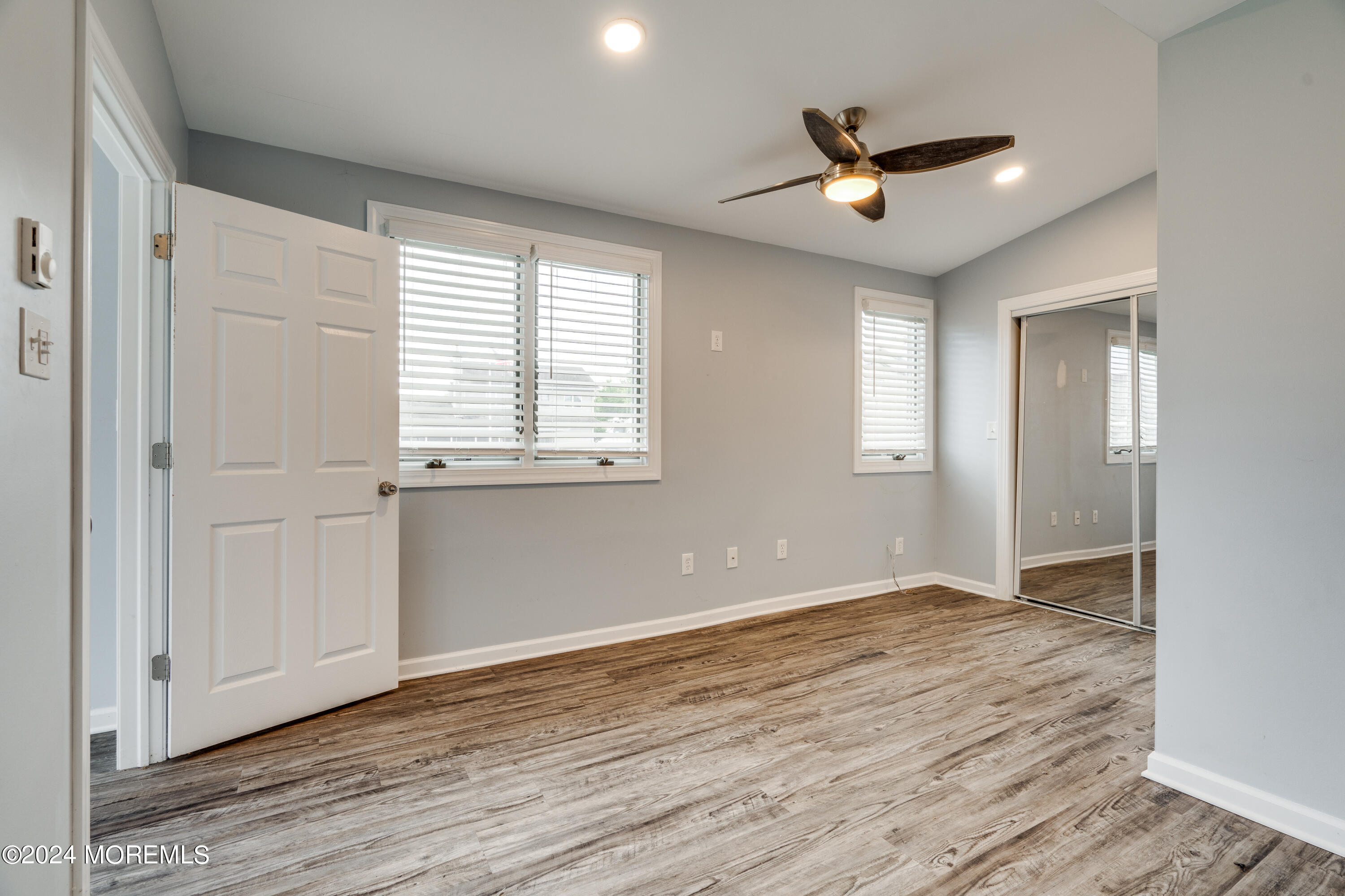 14 Bayview Drive Waretown, NJ 08758 - Photo 14 of 35 a view of an empty room with wooden floor and a window