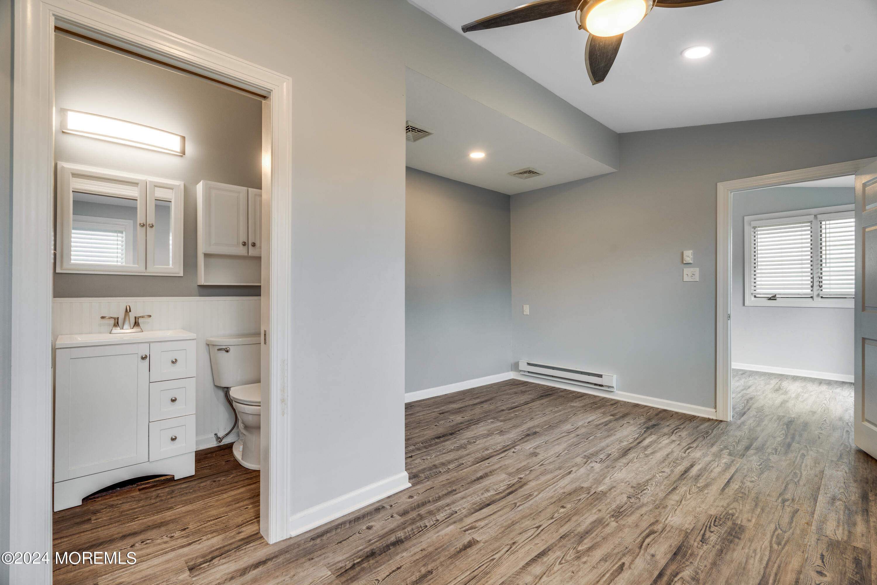 14 Bayview Drive Waretown, NJ 08758 - Photo 15 of 35 wooden floor in an empty room with a mirror