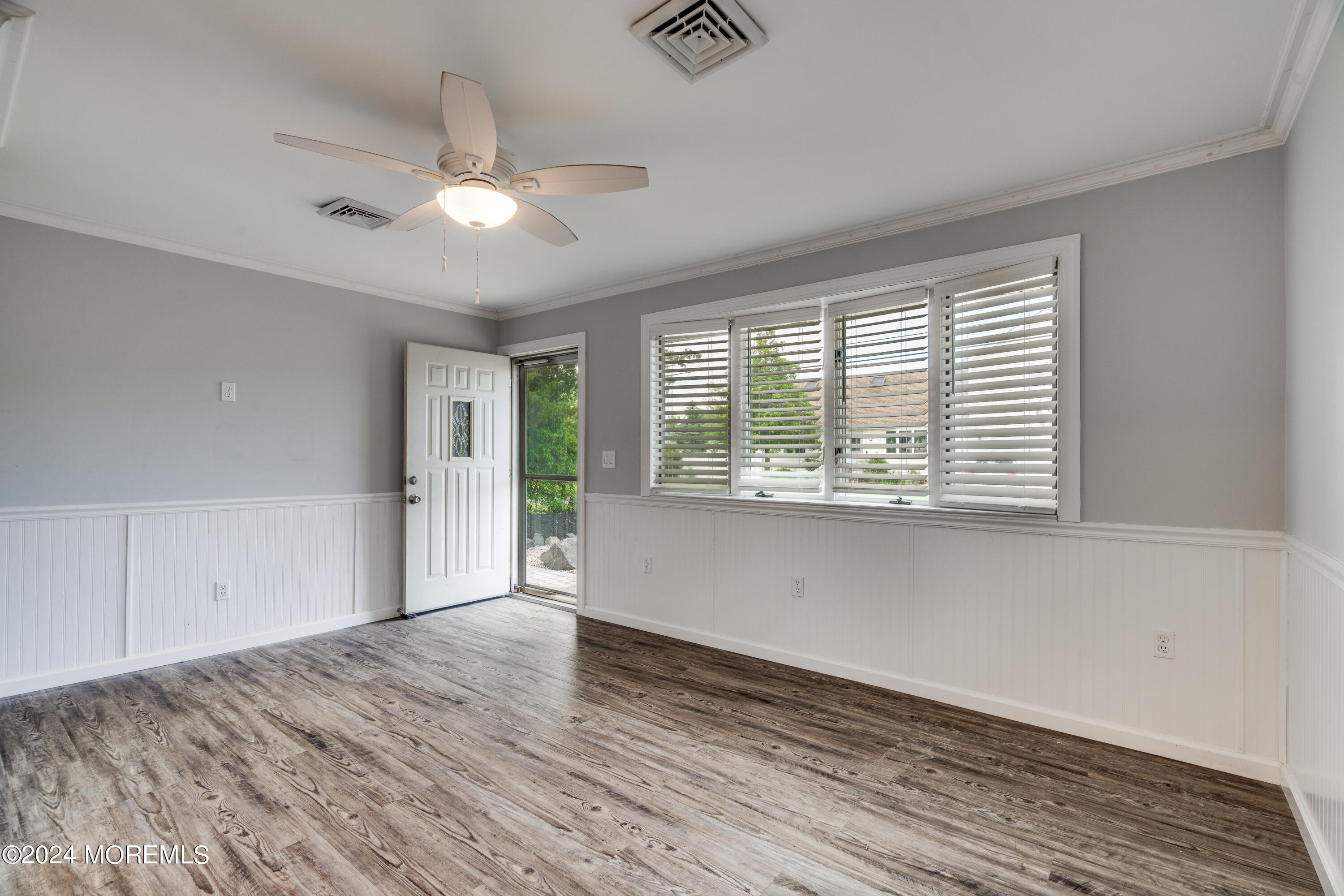 14 Bayview Drive Waretown, NJ 08758 - Photo 7 of 35 a view of an empty room with wooden floor and a window