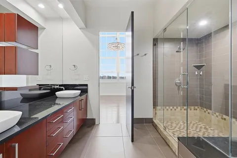 a bathroom with a double vanity sink and mirror