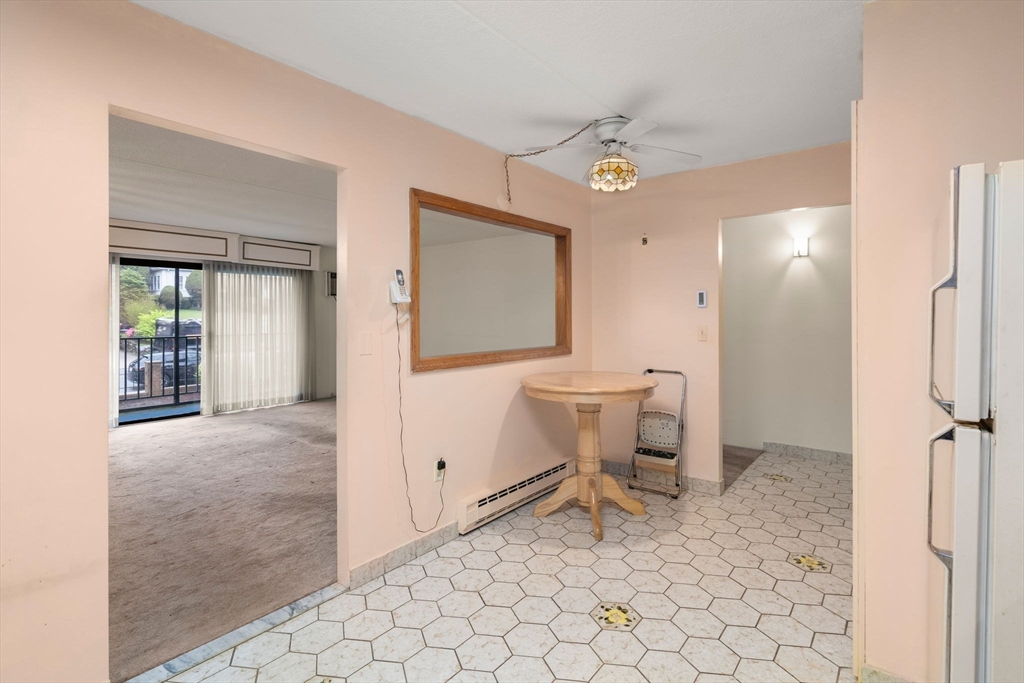 190 High Street, Unit 409 Medford, MA 02155 - Photo 11 of 30 a spacious bathroom with a toilet a sink and mirror