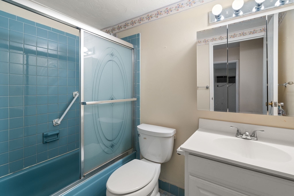 190 High Street, Unit 409 Medford, MA 02155 - Photo 24 of 30 a bathroom with a sink a toilet and shower