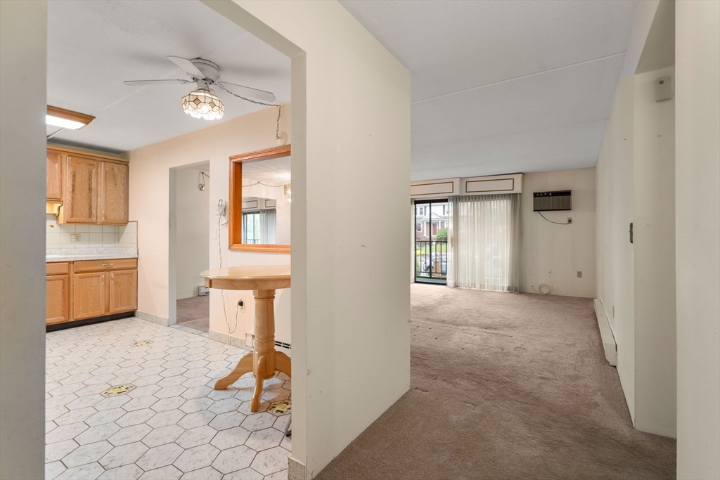 190 High Street, Unit 409 Medford, MA 02155 - Photo 8 of 30 a view of a livingroom with wooden floor and a ceiling fan