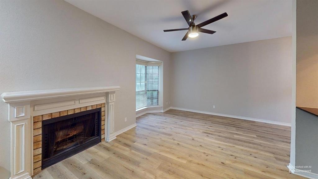 7025 Hemlock Avenue, Unit 103 Dallas, TX 75231 - Photo 2 of 8 an empty room with windows and a fireplace