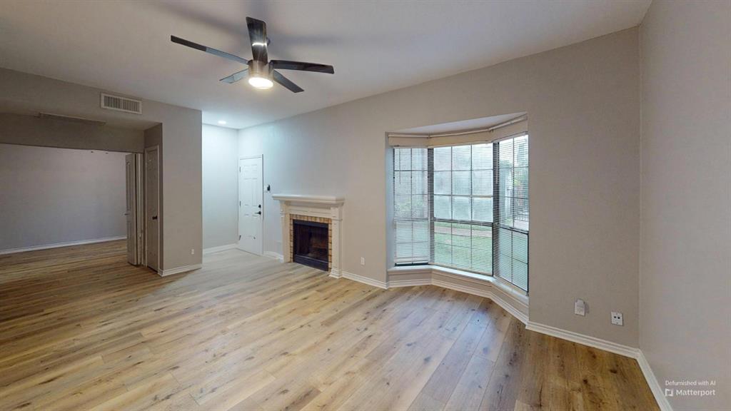 7025 Hemlock Avenue, Unit 103 Dallas, TX 75231 - Photo 3 of 8 a view of empty room with wooden floor and fan