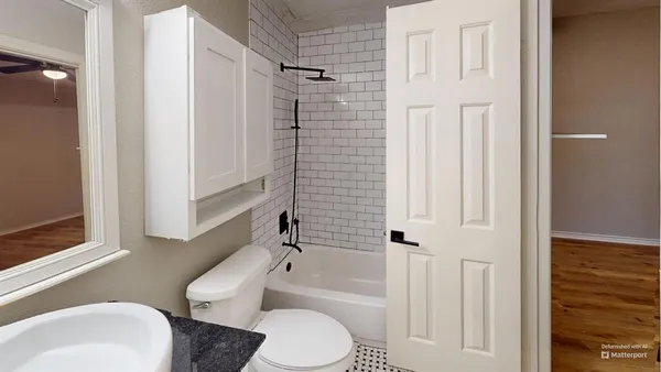 a white toilet sitting next to a bathroom sink