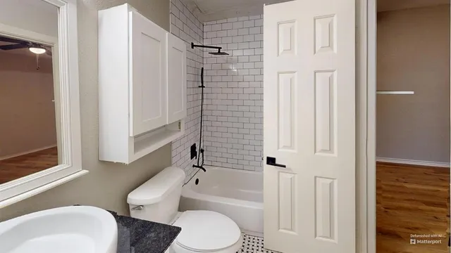 a white toilet sitting next to a bathroom sink