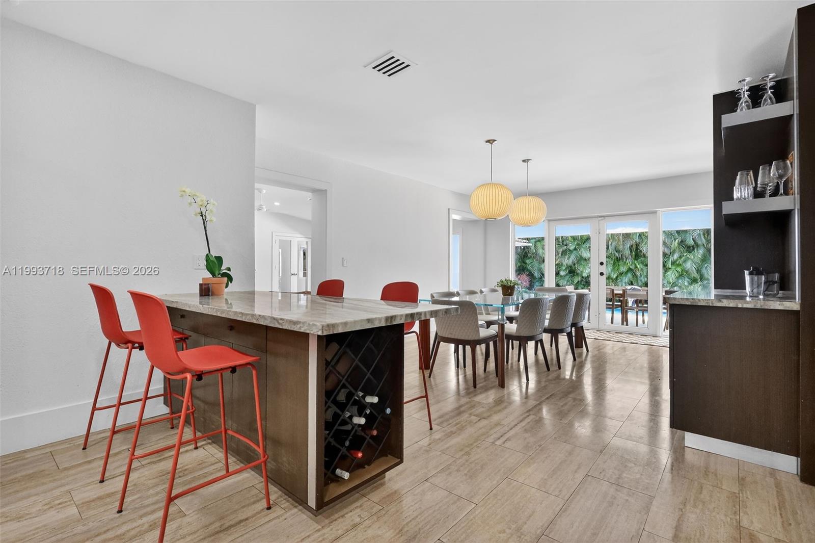3258 Riviera Drive Coral Gables, FL 33134 - Photo 13 of 43 a view of a dining room with furniture and wooden floor