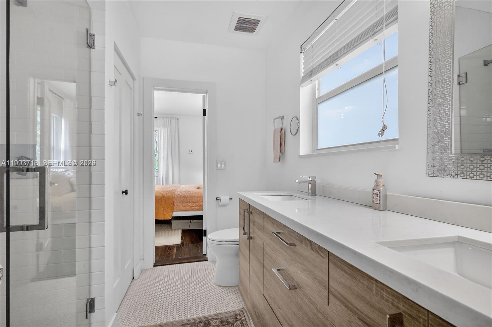 3258 Riviera Drive Coral Gables, FL 33134 - Photo 16 of 43 a bathroom with a sink and a mirror