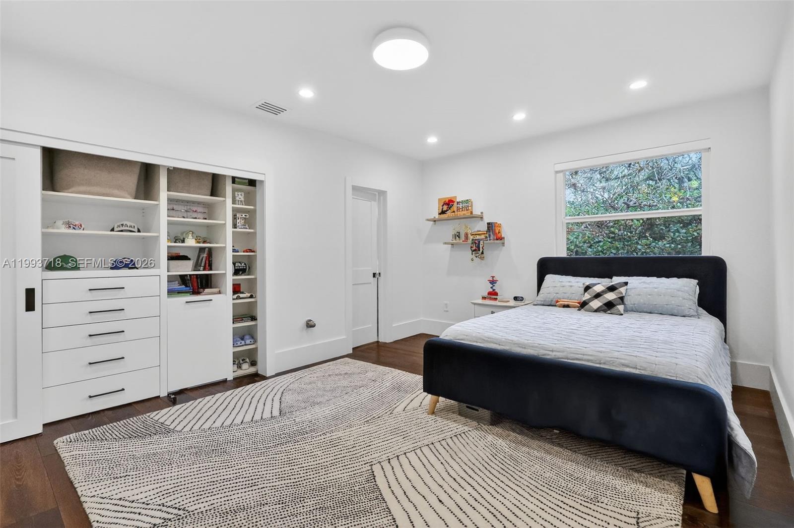 3258 Riviera Drive Coral Gables, FL 33134 - Photo 18 of 43 a bedroom with a bed and a window