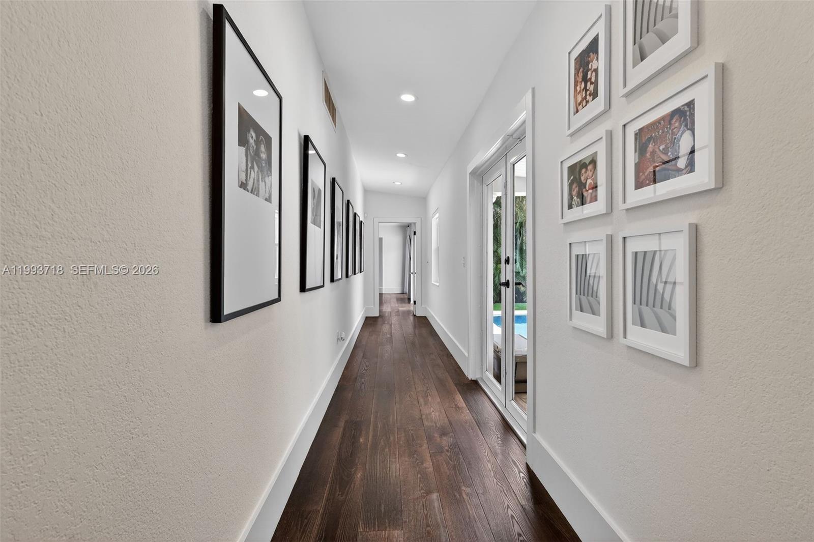3258 Riviera Drive Coral Gables, FL 33134 - Photo 19 of 43 a view of a hallway with wooden floor and staircase
