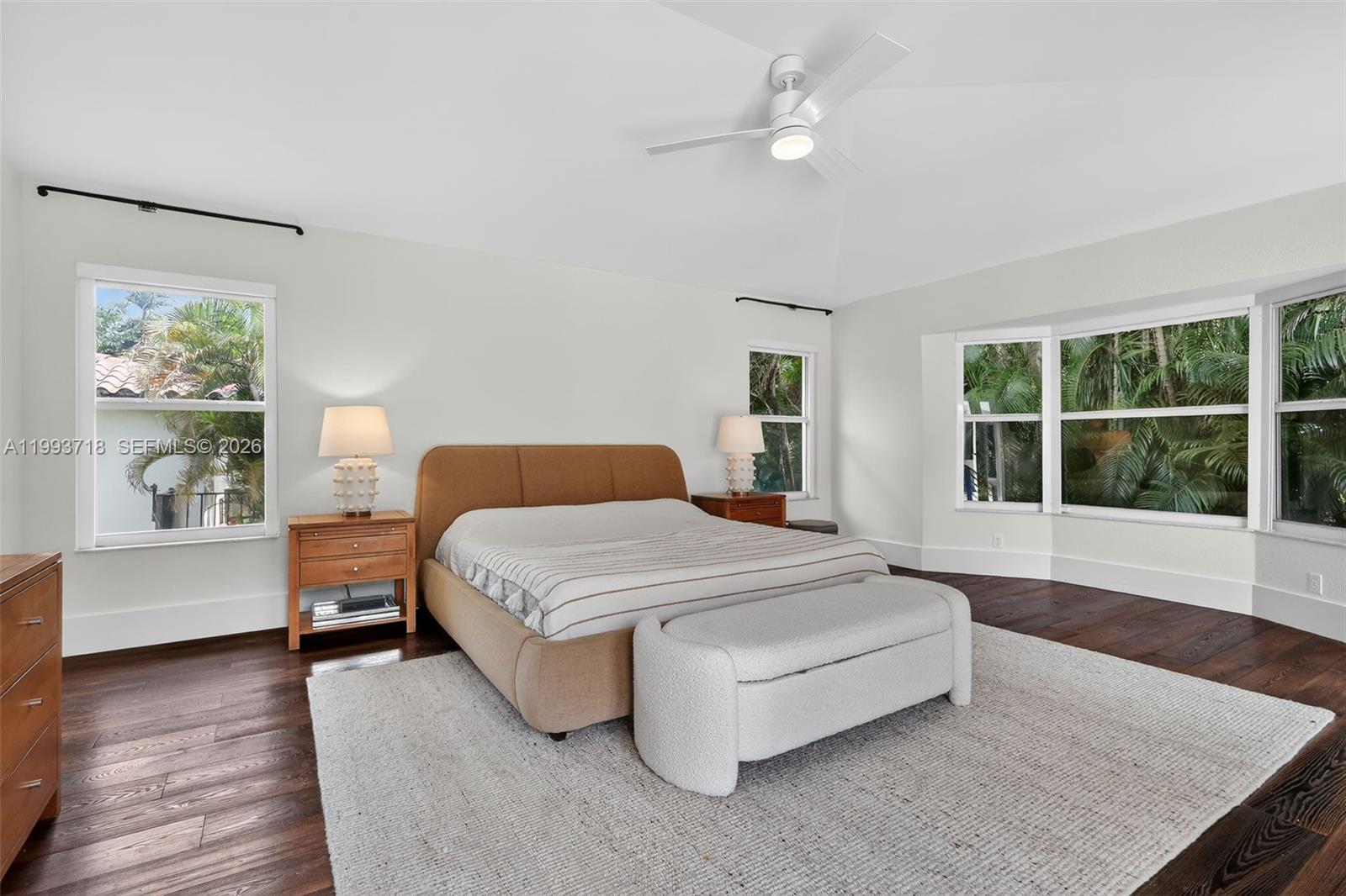 3258 Riviera Drive Coral Gables, FL 33134 - Photo 21 of 43 a spacious bedroom with a large bed and a chandelier