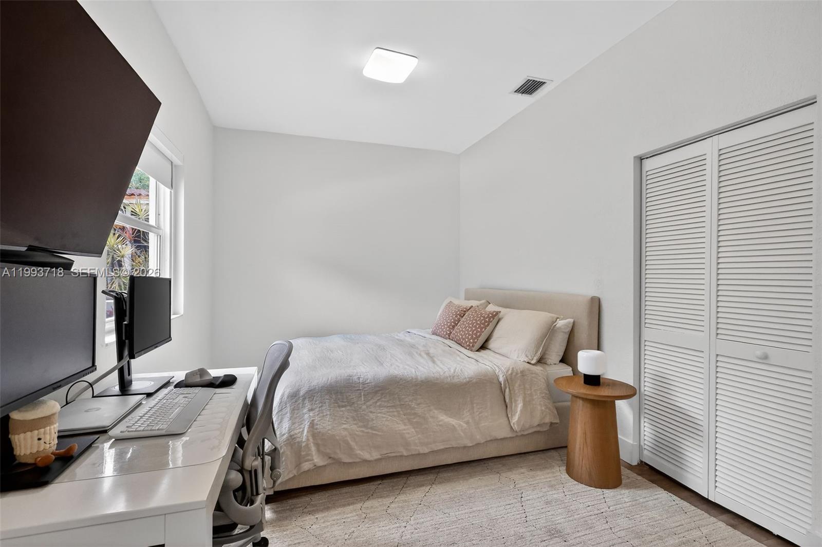 3258 Riviera Drive Coral Gables, FL 33134 - Photo 26 of 43 a bedroom with a bed and a flat screen tv