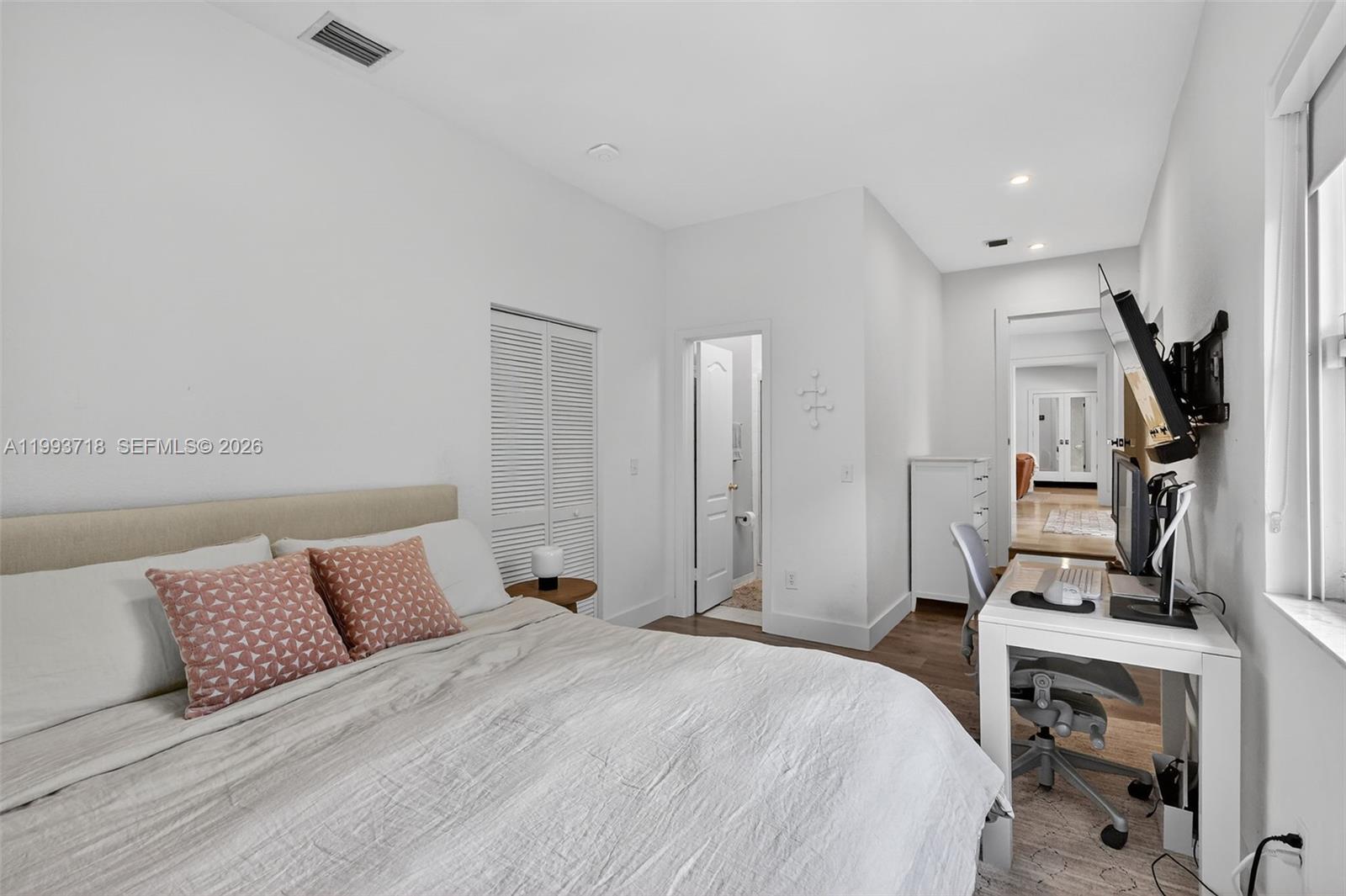 3258 Riviera Drive Coral Gables, FL 33134 - Photo 27 of 43 a bedroom with a bed and a flat screen tv
