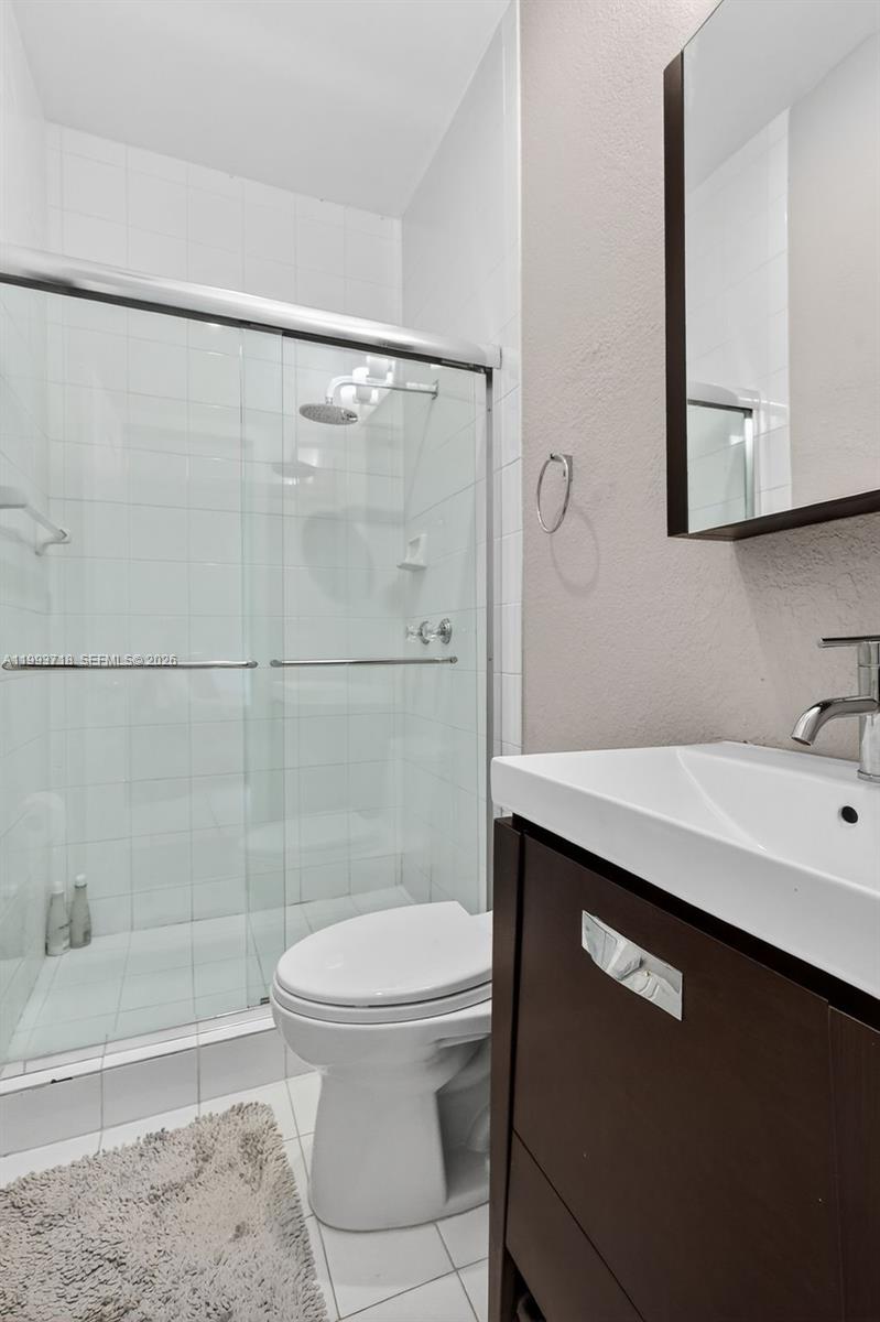3258 Riviera Drive Coral Gables, FL 33134 - Photo 28 of 43 a bathroom with a sink a toilet and shower