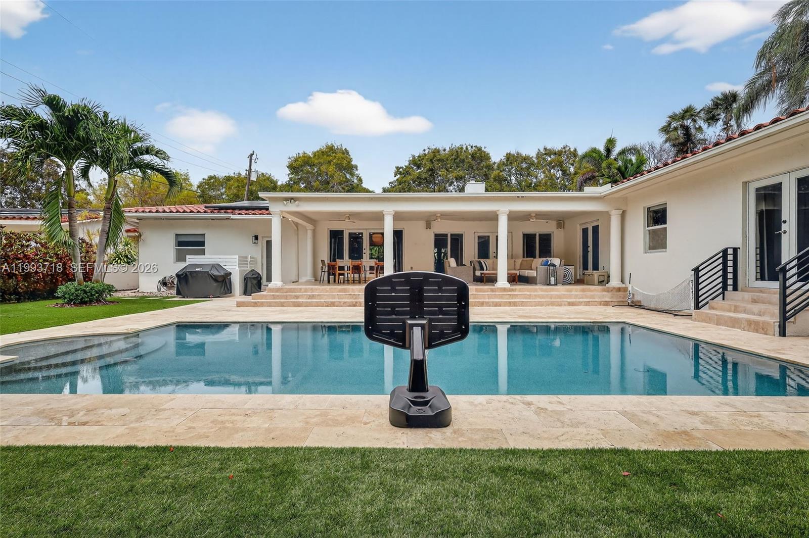 3258 Riviera Drive Coral Gables, FL 33134 - Photo 33 of 43 a front view of a house with porch and swimming pool