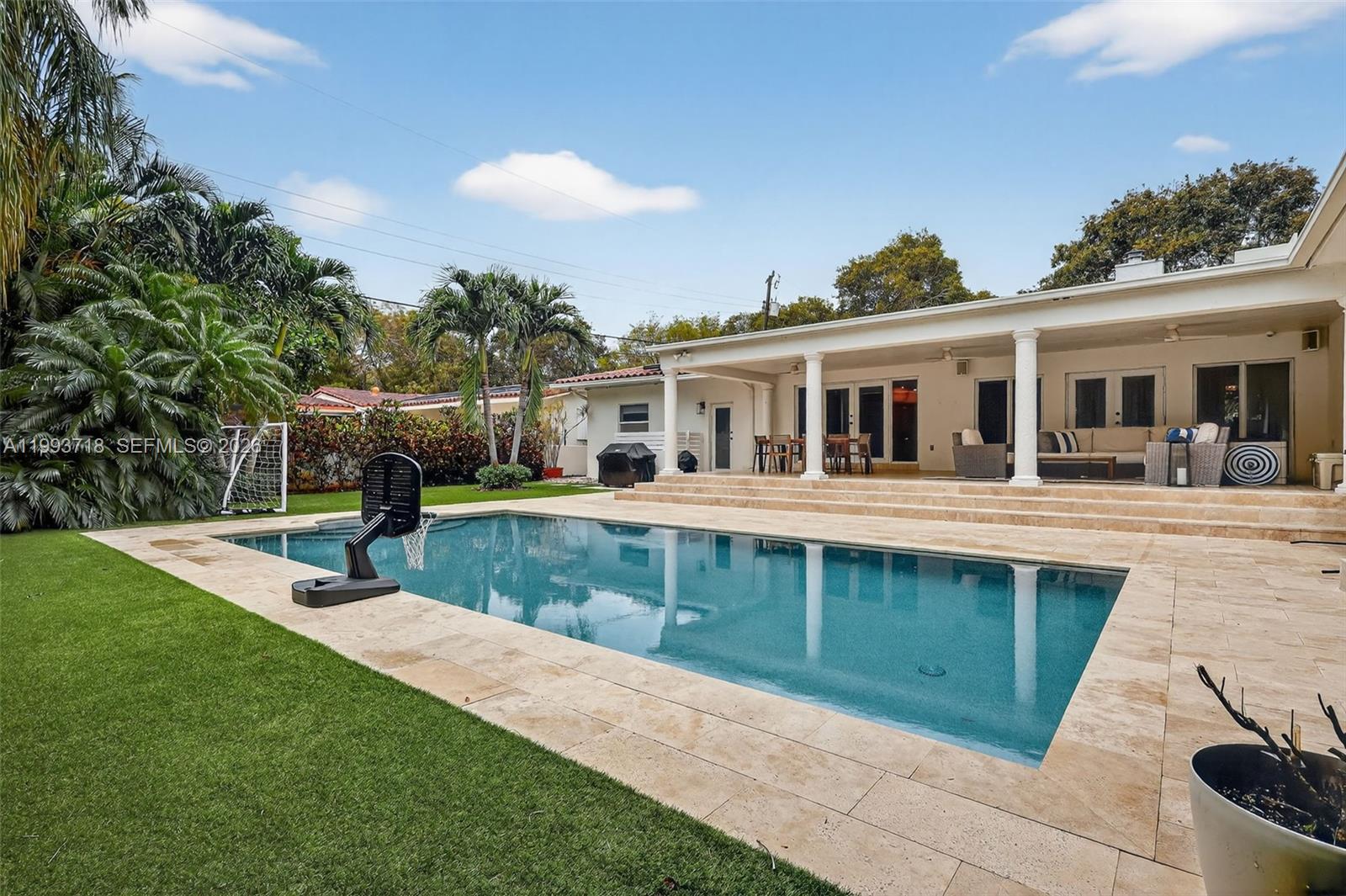 3258 Riviera Drive Coral Gables, FL 33134 - Photo 34 of 43 a front view of a house with a yard