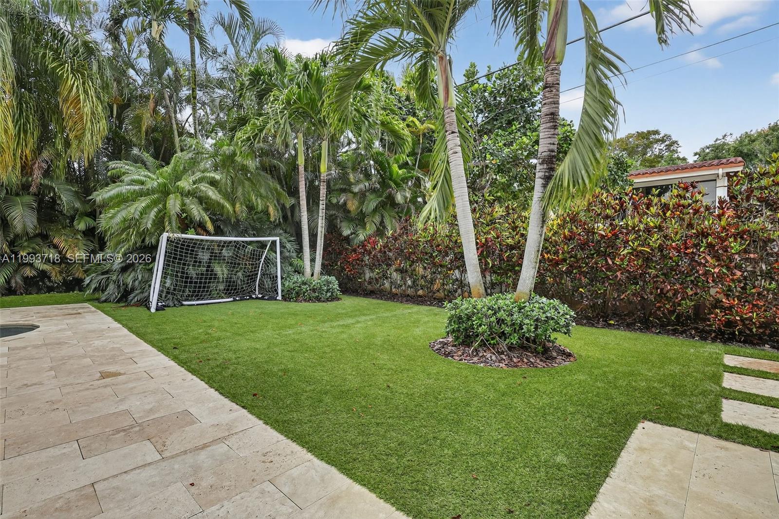 3258 Riviera Drive Coral Gables, FL 33134 - Photo 35 of 43 a view of a yard with plants and a fountain