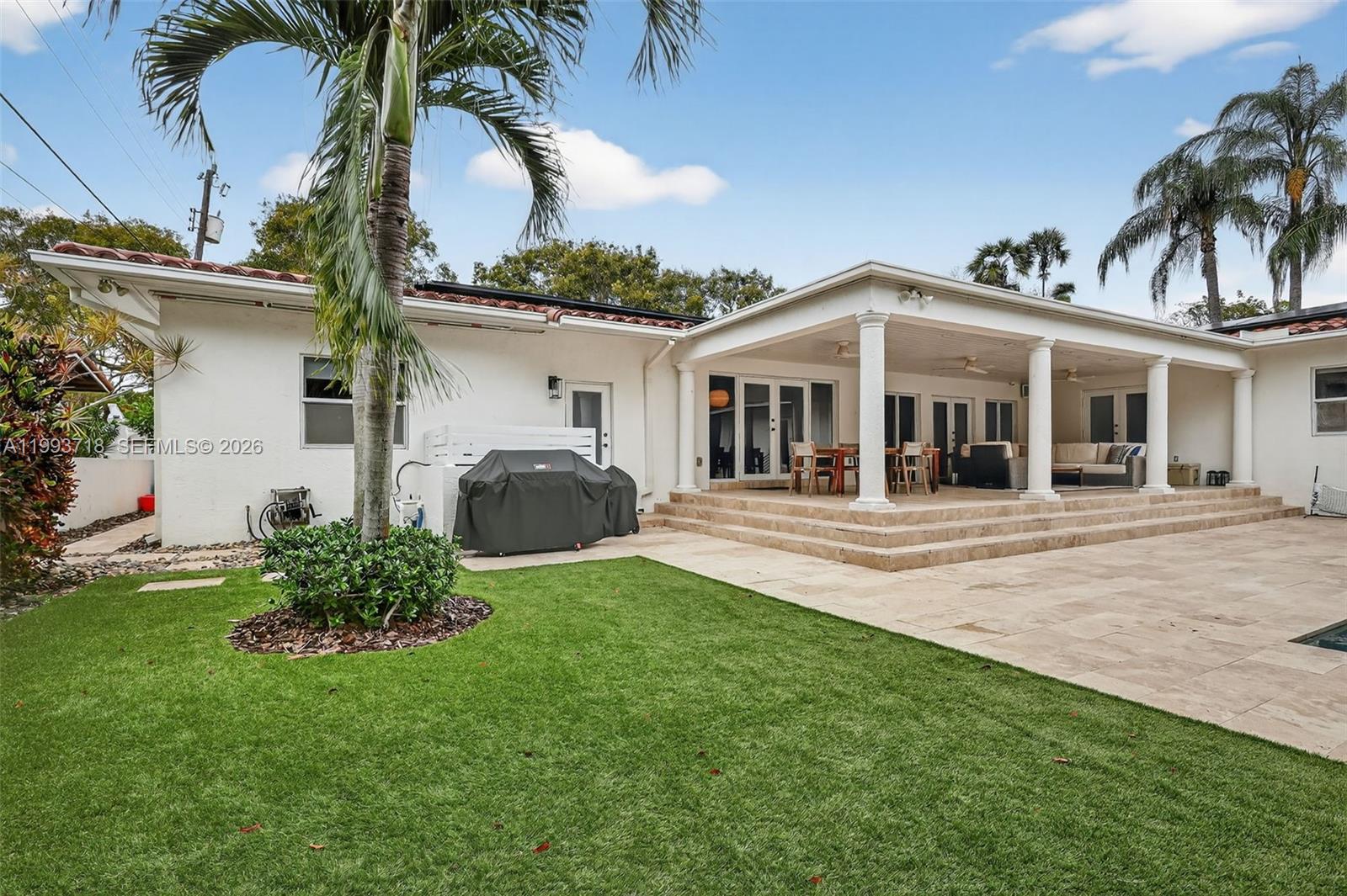 3258 Riviera Drive Coral Gables, FL 33134 - Photo 36 of 43 a front view of a house with a garden