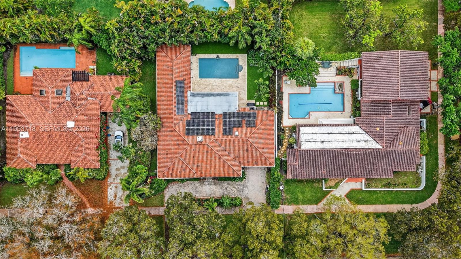 3258 Riviera Drive Coral Gables, FL 33134 - Photo 40 of 43 aerial view of a house with a yard and plants