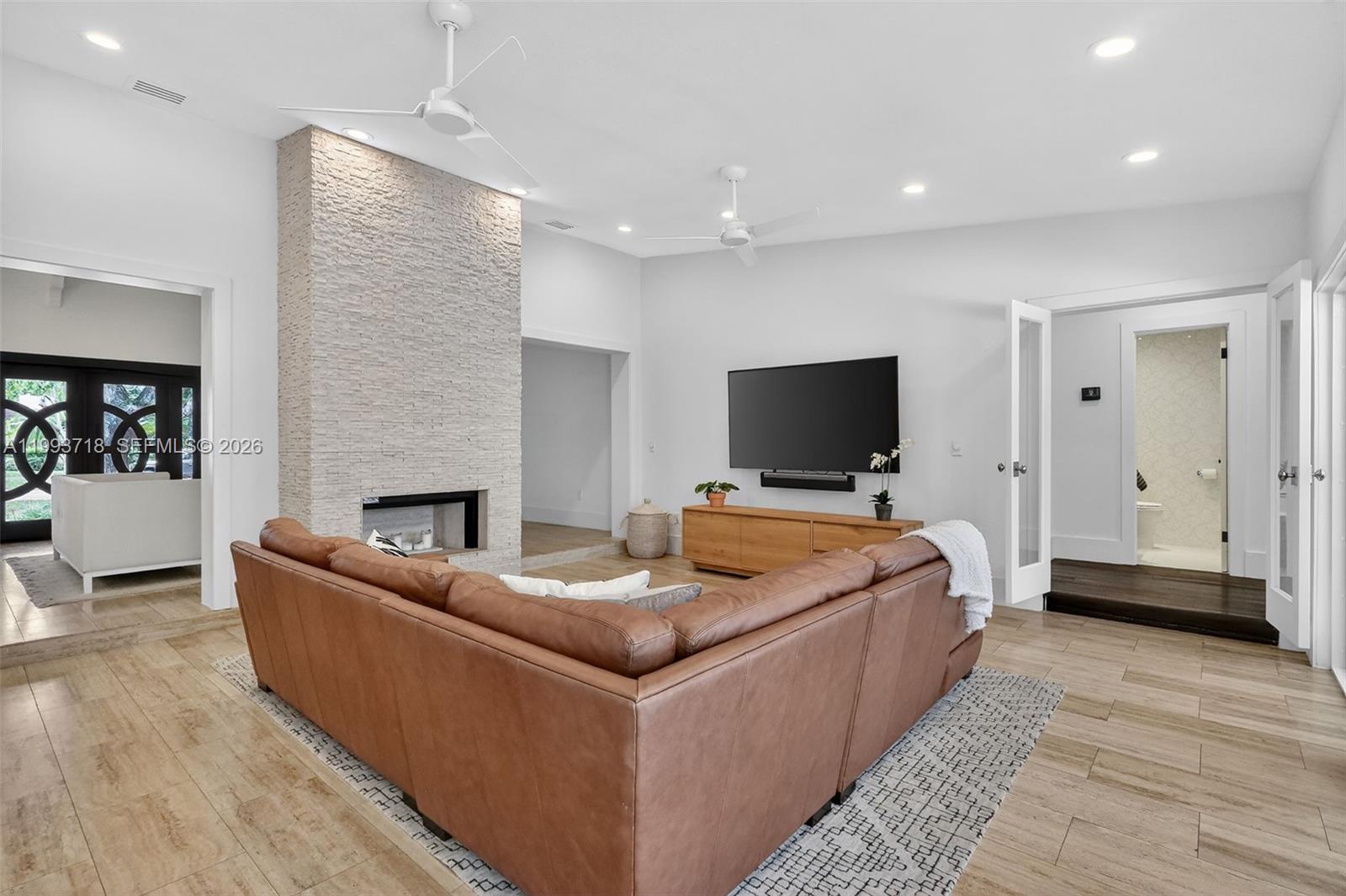 3258 Riviera Drive Coral Gables, FL 33134 - Photo 8 of 43 a living room with furniture and a flat screen tv
