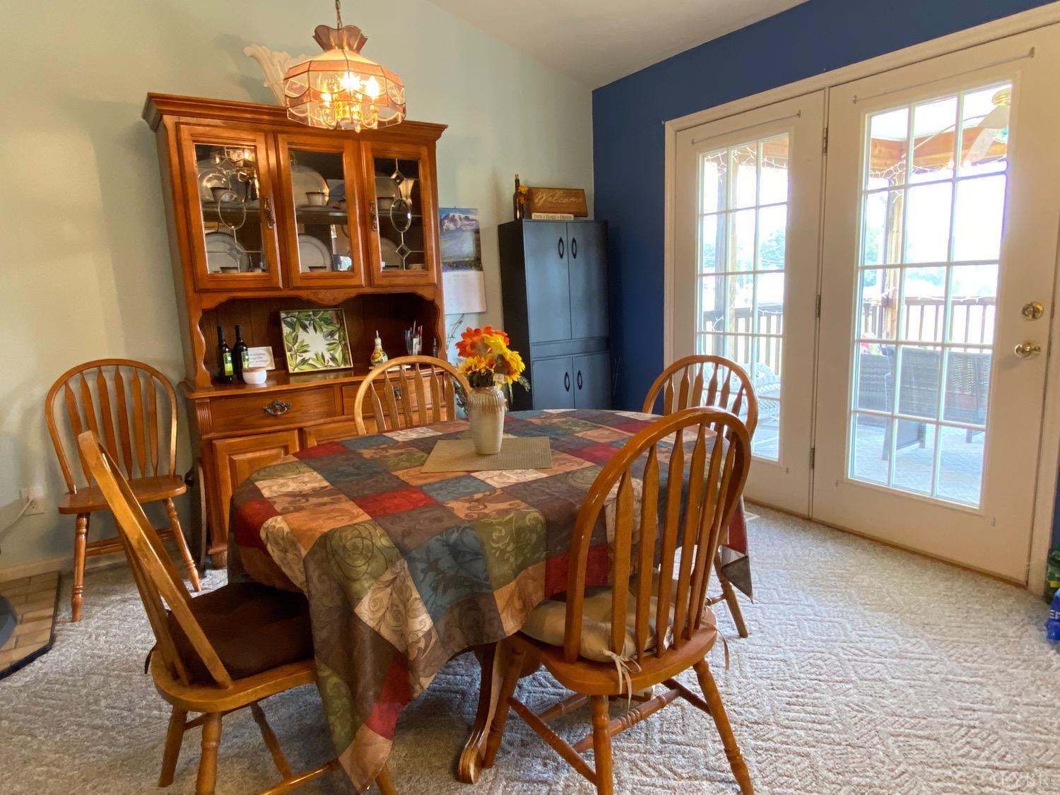 1149 Emmaus Church Road Moneta, VA 24121 - Photo 19 of 51 a dining room with furniture a chandelier and wooden floor