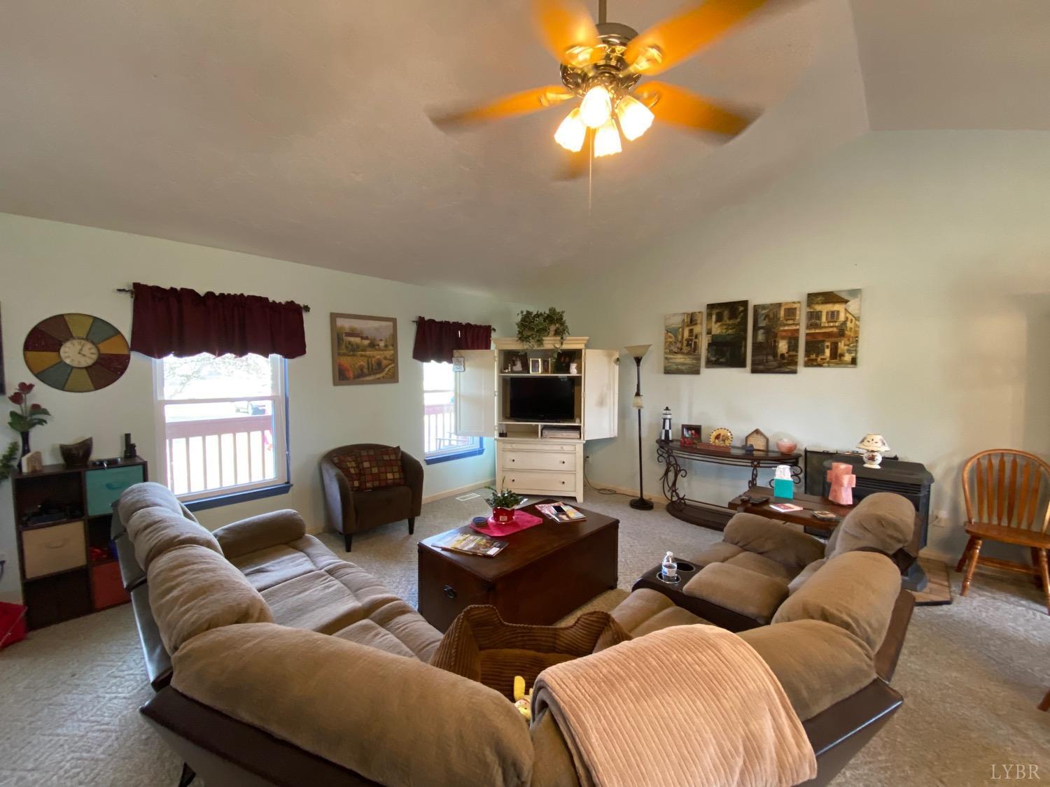 1149 Emmaus Church Road Moneta, VA 24121 - Photo 22 of 51 a living room with furniture a ceiling fan and a window