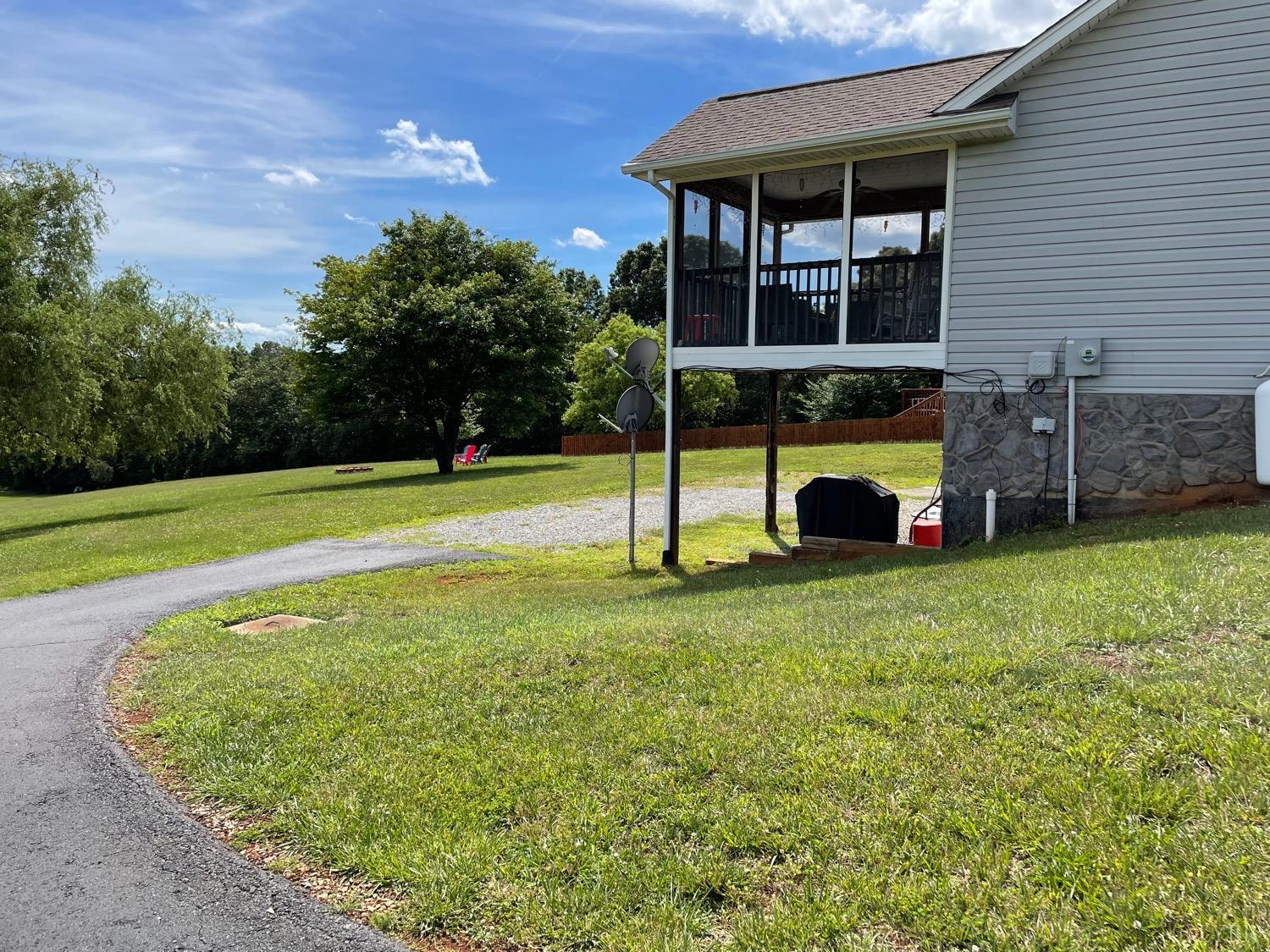 1149 Emmaus Church Road Moneta, VA 24121 - Photo 48 of 51 a view of a house with a backyard and a patio