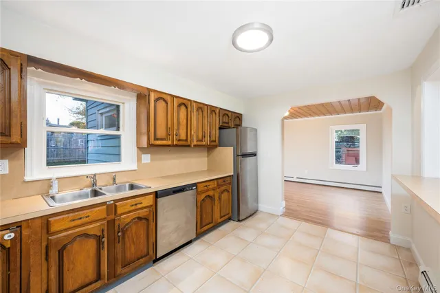 a spacious bathroom with a granite countertop sink and a mirror