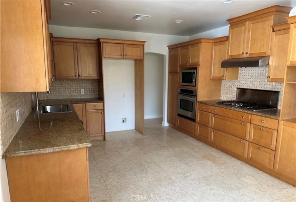 2065 Watson Street Glendale, CA 91201 - Photo 2 of 11 a kitchen with stainless steel appliances granite countertop a stove a sink and a refrigerator