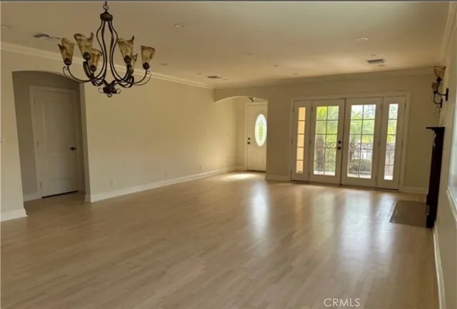 a view of a room with wooden floor and windows