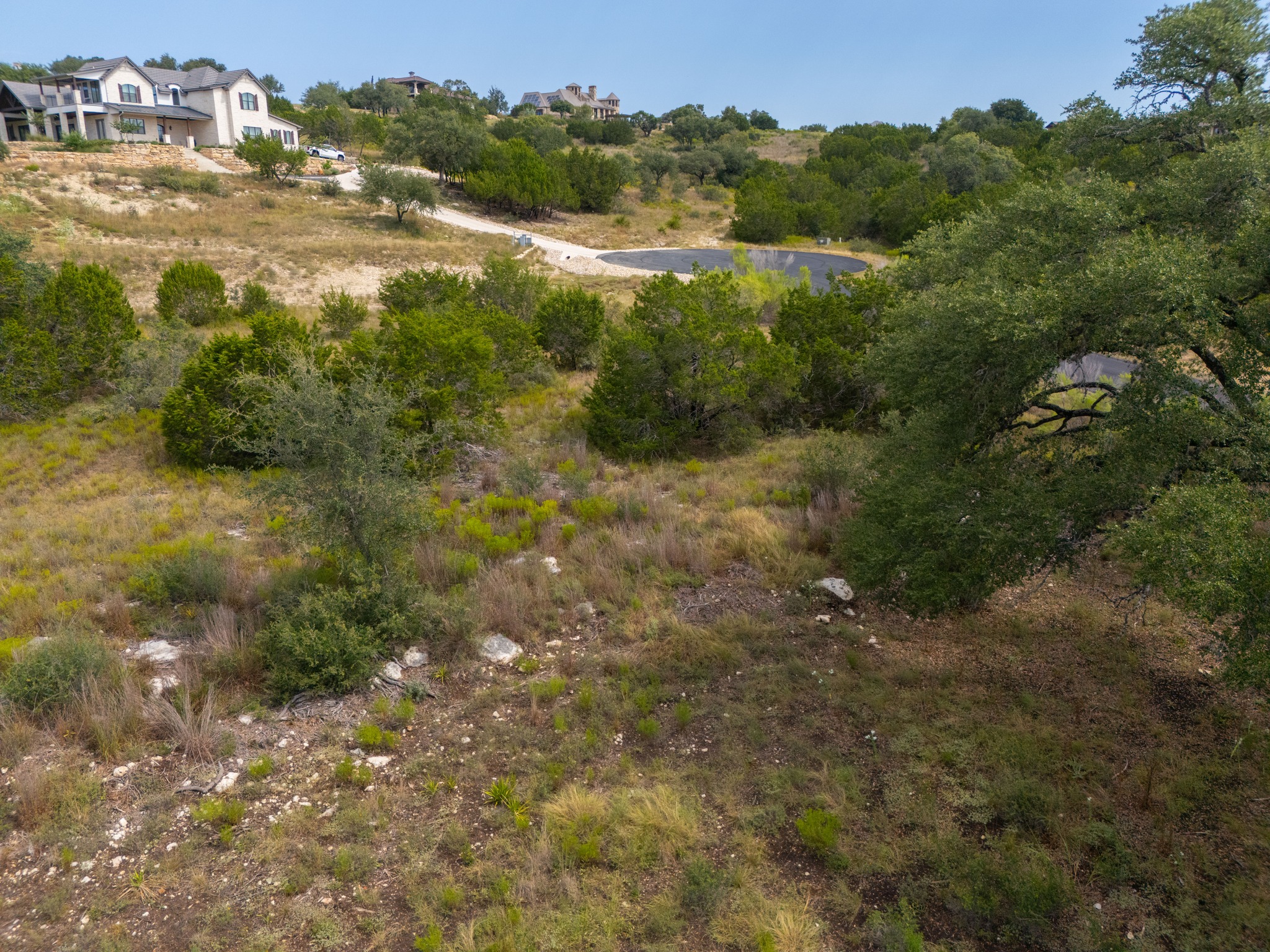 115 Upper River Place Spring Branch, TX 78070 - Photo 14 of 19 Mature trees and rolling hills frame this expansive hillside building site.