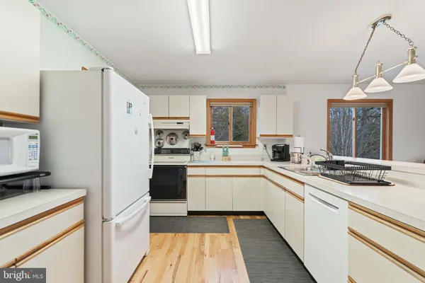a view of a chairs and table in a balcony