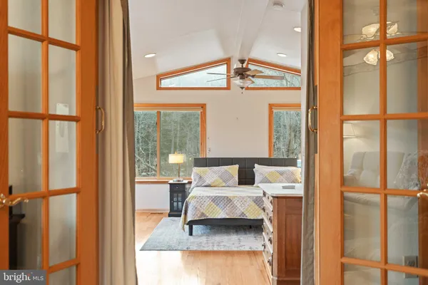 a view of a room that has a large window and front door