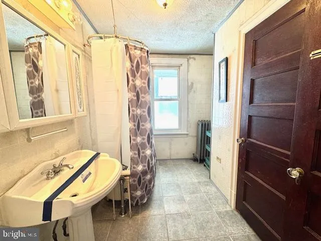 a bathroom with a toilet tub and shower