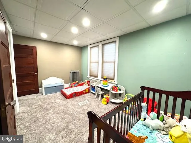 an empty room with windows and ceiling fan