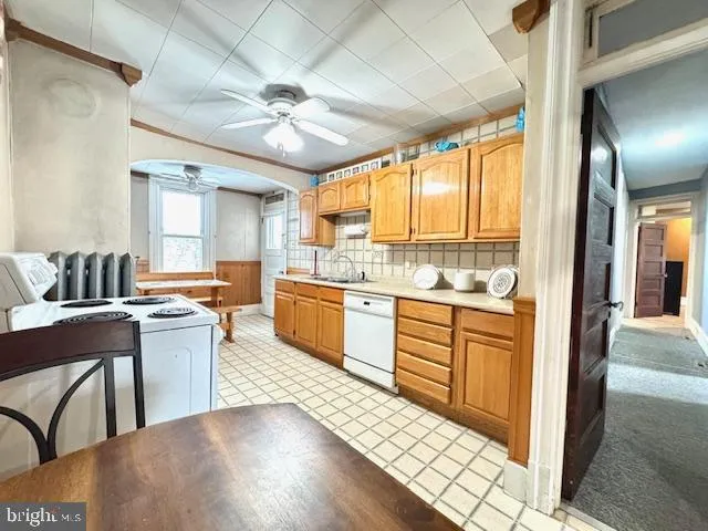 a large white kitchen with a large window