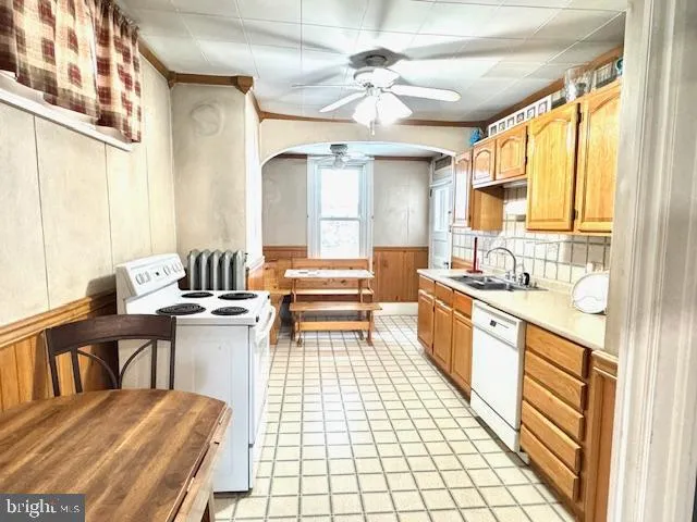 a kitchen with a sink appliances and cabinets
