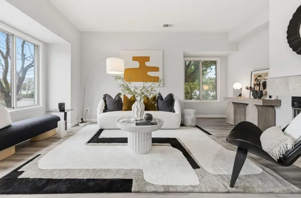 a living room with furniture a fireplace and a window