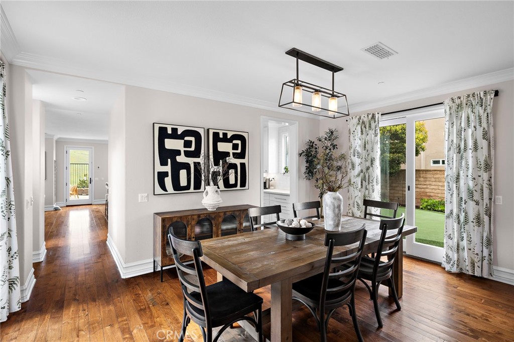 33 Christopher Street Ladera Ranch, CA 92694 - Photo 13 of 58 a view of a dining room with furniture and wooden floor