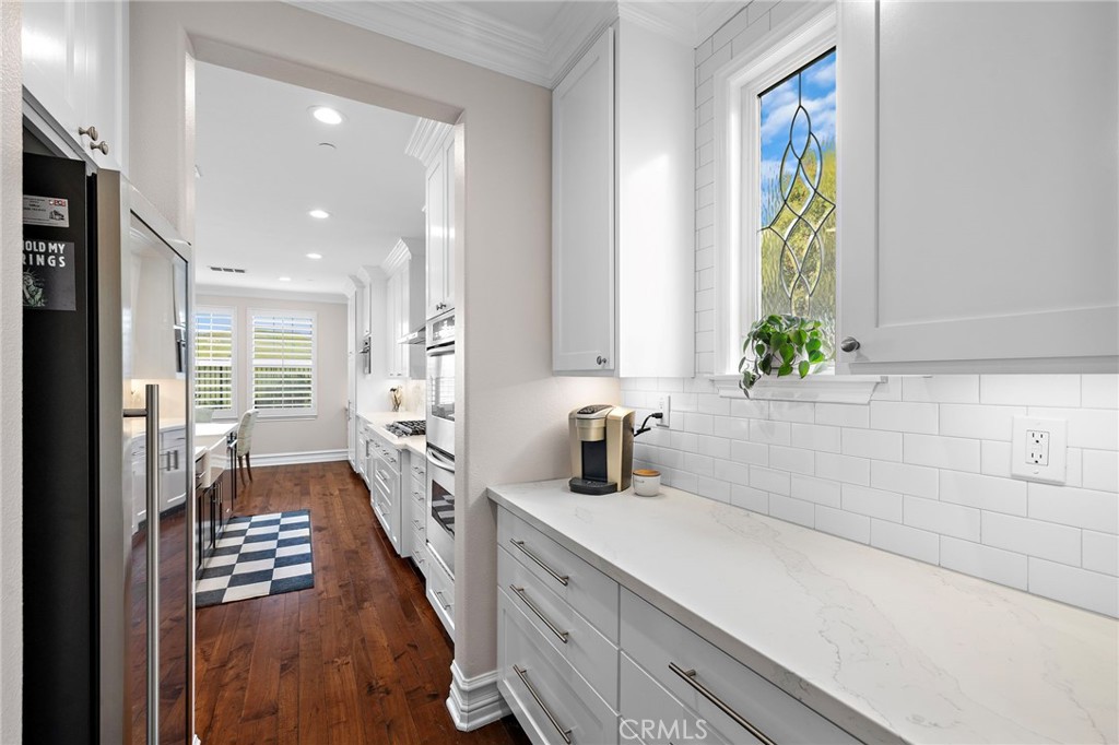 33 Christopher Street Ladera Ranch, CA 92694 - Photo 23 of 58 a large white kitchen with a window and refrigerator