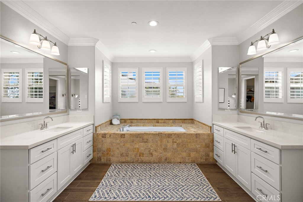 33 Christopher Street Ladera Ranch, CA 92694 - Photo 29 of 58 a spacious bathroom with a double vanity sink large mirror and a bathtub