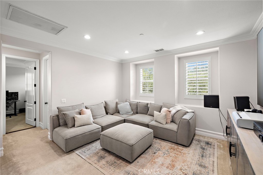 33 Christopher Street Ladera Ranch, CA 92694 - Photo 32 of 58 a living room with furniture white walls and a table